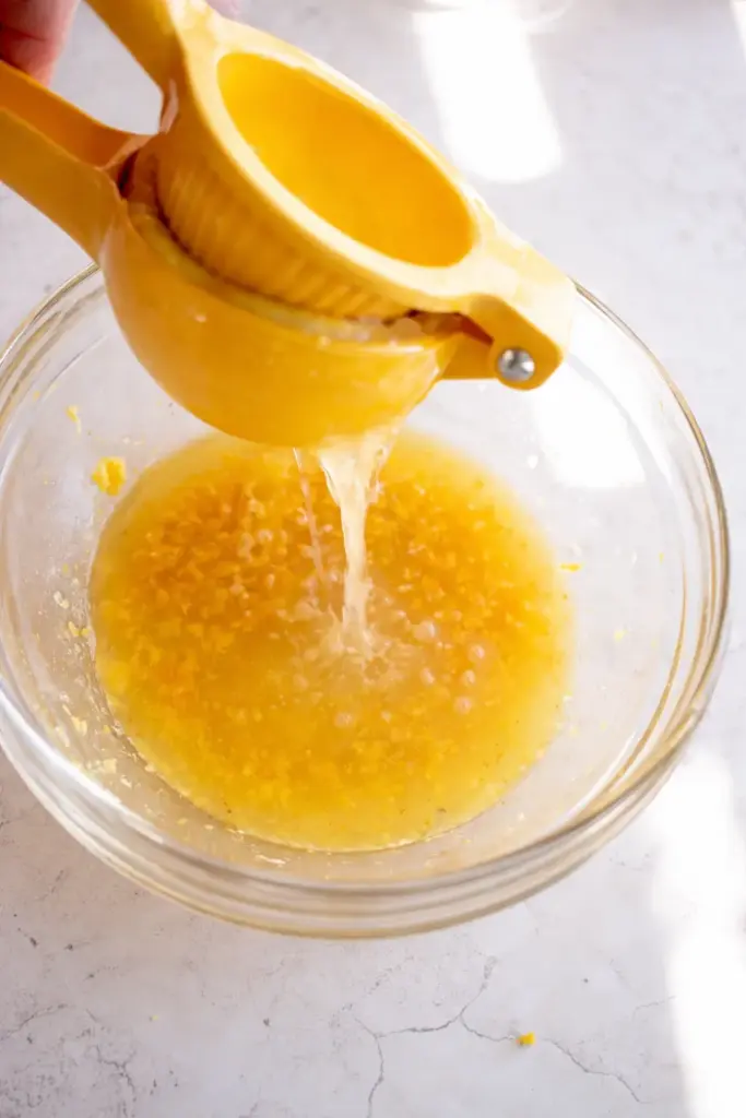 Zesting fresh lemon into mixing bowl