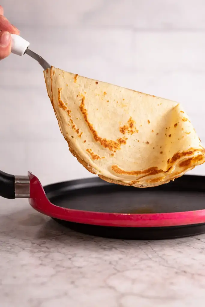 Whisking crêpe batter in mixing bowl