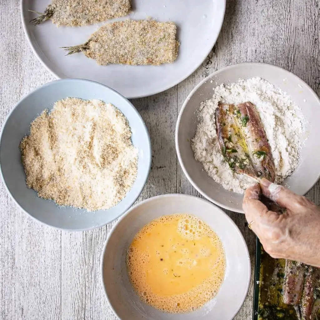 Frying sardines in skillet until golden