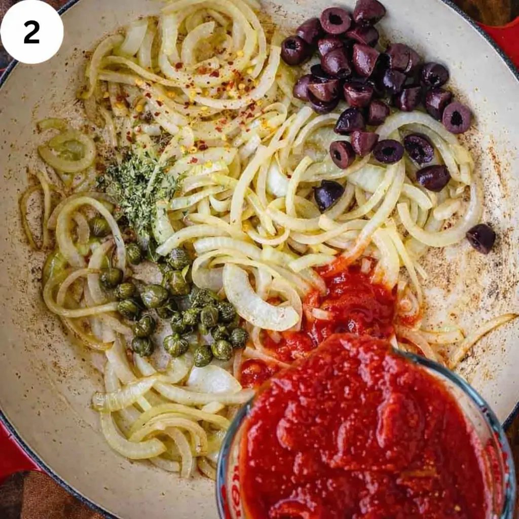 Simmering tomato sauce with olives and capers