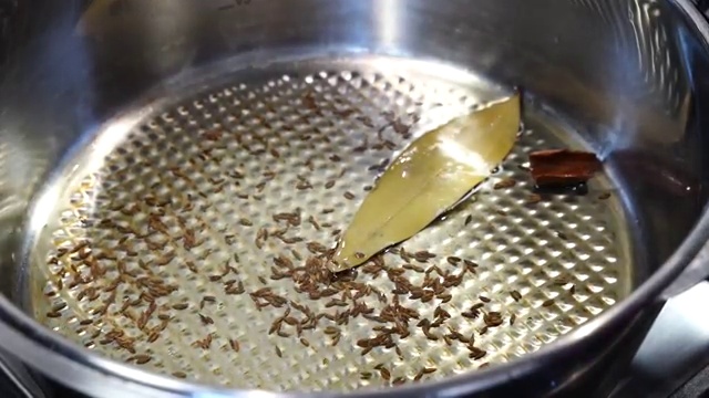 A splash of hot water added to the onion and ginger mixture to prevent spices burning