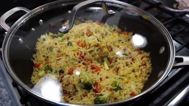 A fresh wedge of lemon squeezed over the hot spiced vegetable rice