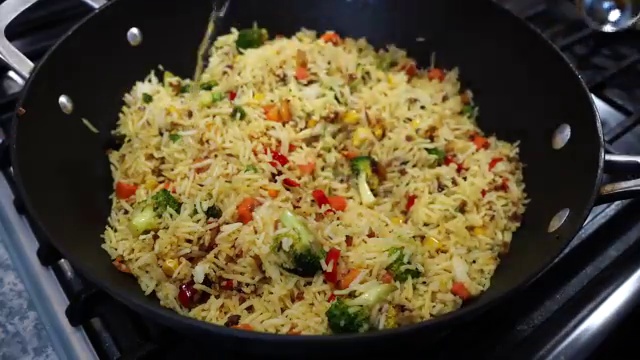 A spoonful of fragrant golden ghee added to finish the hot steamed masala rice