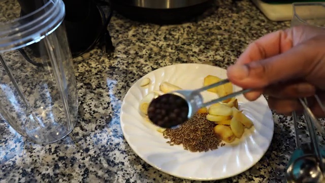 Asafoetida hing and red paprika powder added to the tempered cumin oil off the heat