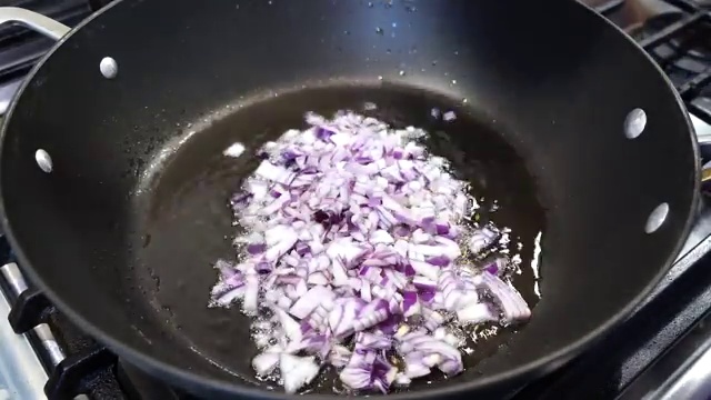 Coarsely chopped garlic sautéing with the softened onions in the pan