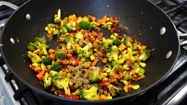 Cold cooked basmati rice added directly over the seasoned vegetable stir-fry