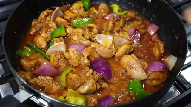 Freshly cracked coarse black pepper sprinkled over the sizzling chicken and peppers
