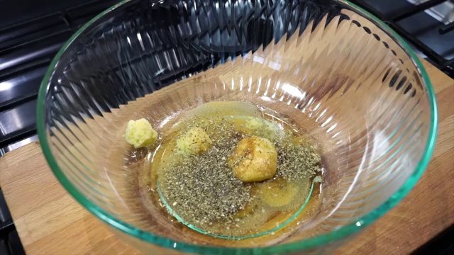 Garlic powder, ground cumin, dried Italian herbs, black pepper, chili powder, paprika, salt, and brown sugar added to the bowl