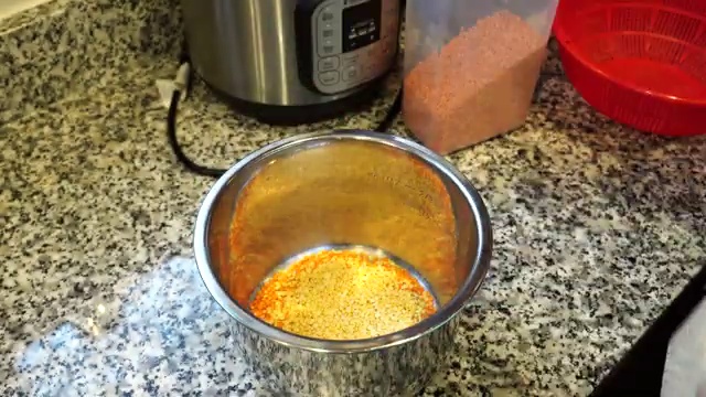 Hot water poured over lentils and aromatics in the pressure cooker pot