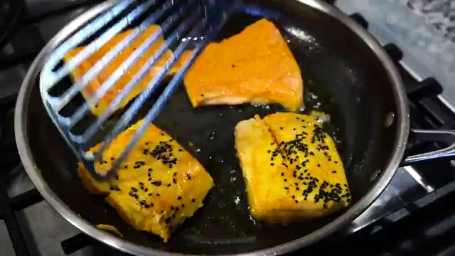 Sea salt and a slit fresh green chili added to the bubbling Bengali fish curry