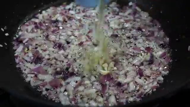 Small fresh green broccoli florets added into the pan with onions and garlic