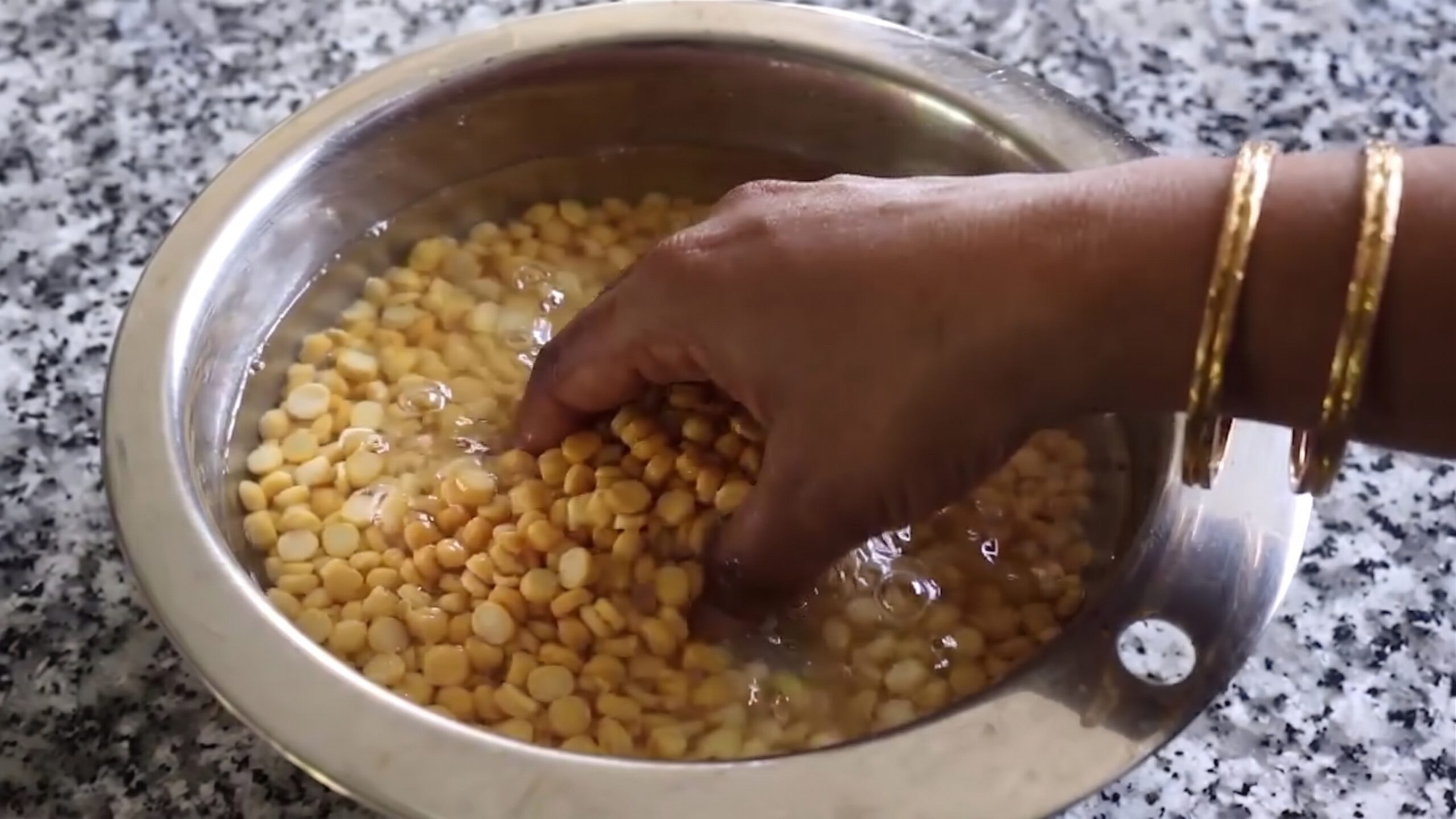 Drained soaked chana dal, grated ginger, and chopped green chili placed in a blender jar