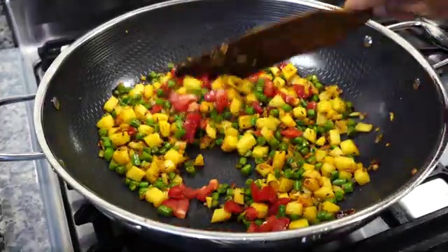 Aloo beans dry sabji covered with a lid and simmering gently in a wide skillet