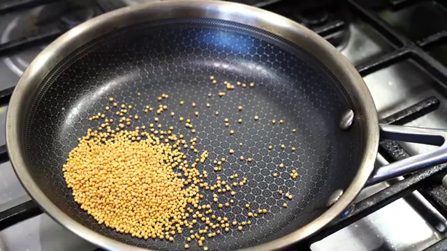 Fragrant roasted whole pickle spices cooling in a glass bowl