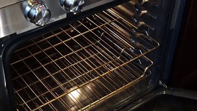 Golden pan drippings spooned over roasting chicken pieces to baste for extra moisture