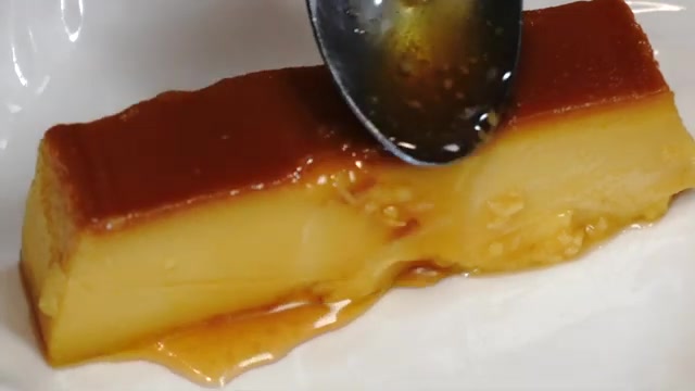 Beautiful finished eggless mango caramel custard sliced and served with golden caramel sauce