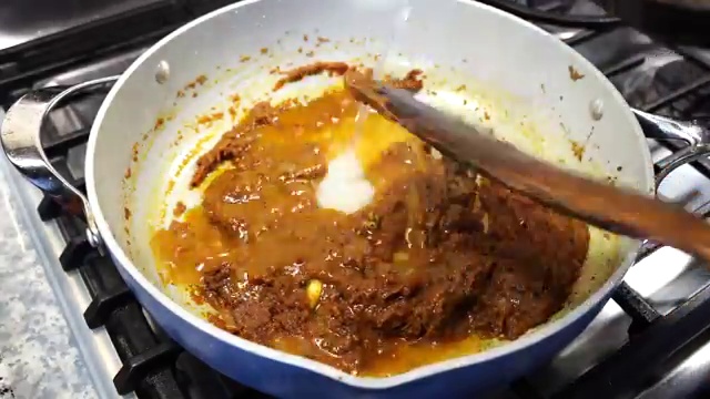Fish curry covered with a lid to gently poach and absorb spice flavors