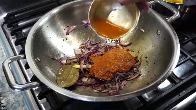 Bengali spice paste cooking gently on low heat with the onions and oil