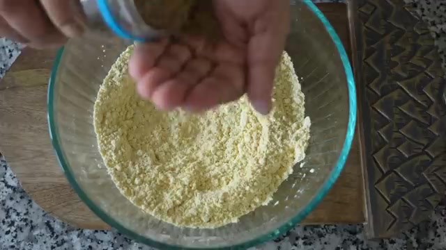 Besan and dry spices being whisked together in a mixing bowl