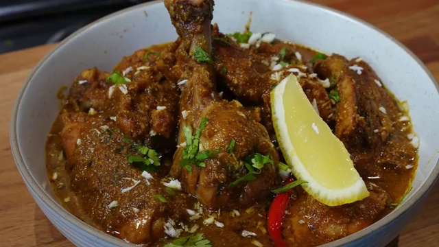Bone-in chicken pieces seasoned and coated with fresh lemon juice and salt in a bowl