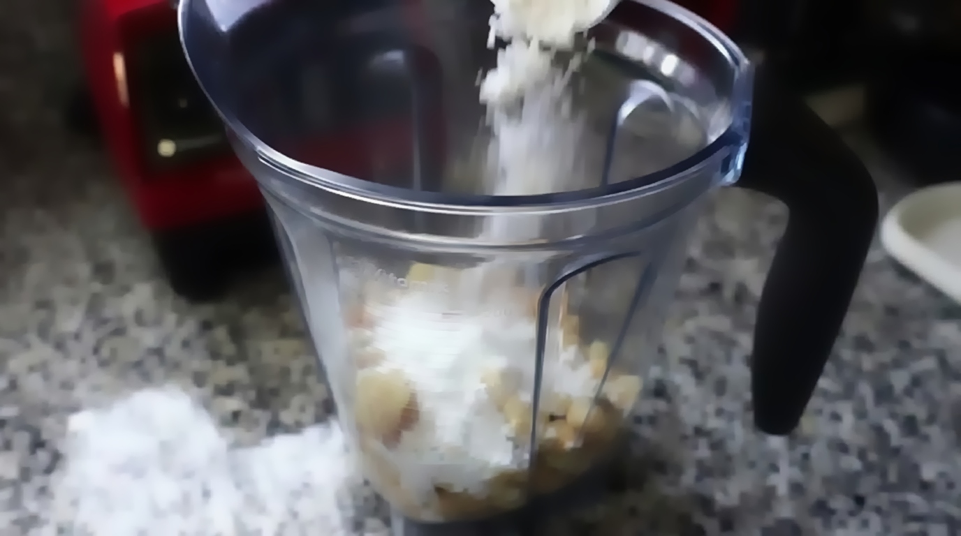 Soaked chickpeas, fresh ginger slice, green chili, gram flour, and rice flour in a blender jar