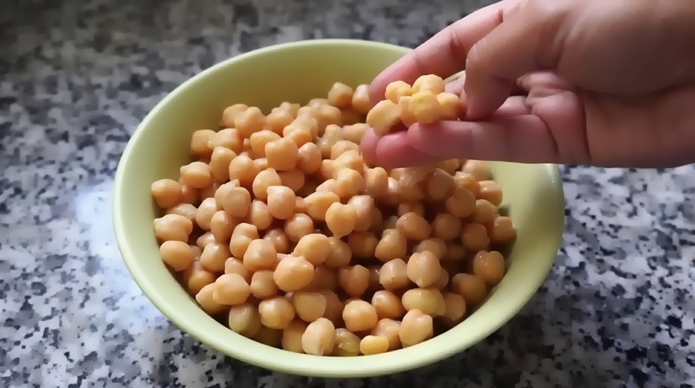 Crispy chickpea chilla carefully flipped with a spatula revealing golden-brown crust