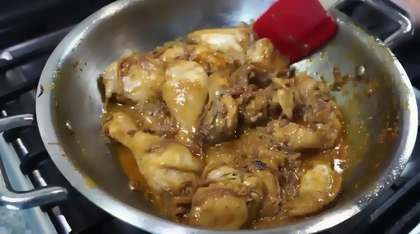 Testing the seasoning of the thick chicken gravy before adding freshly crushed black pepper