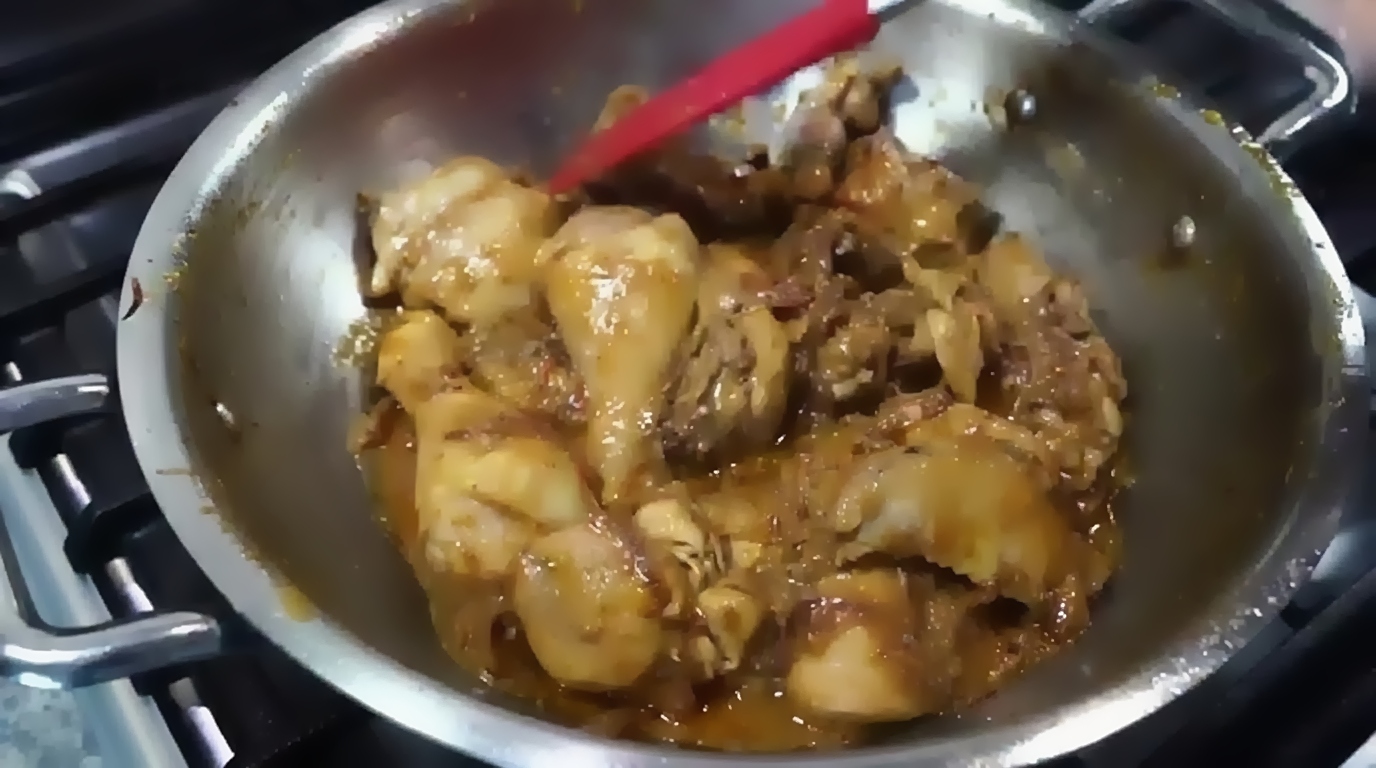 A teaspoon of golden ghee or butter added to enrich the finished chicken curry