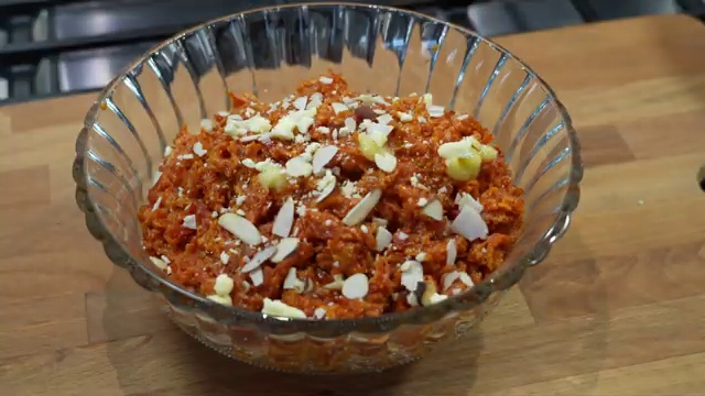 Cooked carrot halwa stored in an airtight glass container for refrigeration