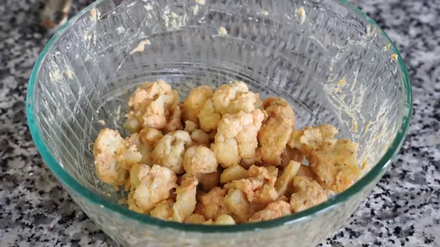 Cauliflower Manchurian florets frying in hot oil until golden-brown and shatteringly crisp