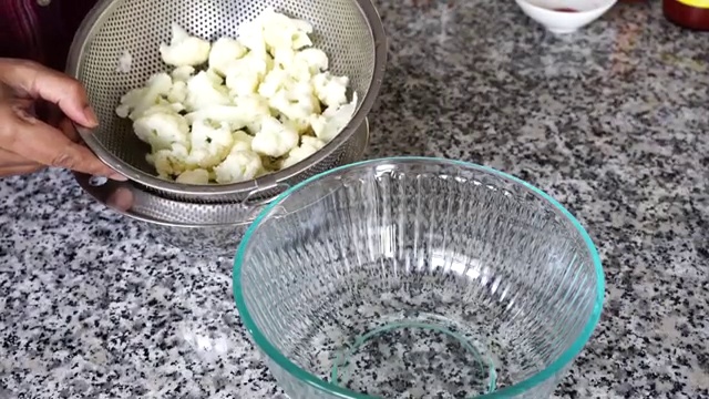 Cauliflower florets gently tossed until evenly coated in a light seasoned batter