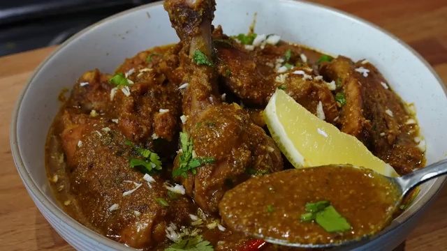 Leftover Chicken Xacuti curry being gently reheated on the stove with a splash of hot water