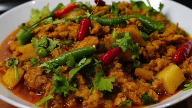 Chicken keema curry served as a complete Indian meal with steamed rice, roti, and naan