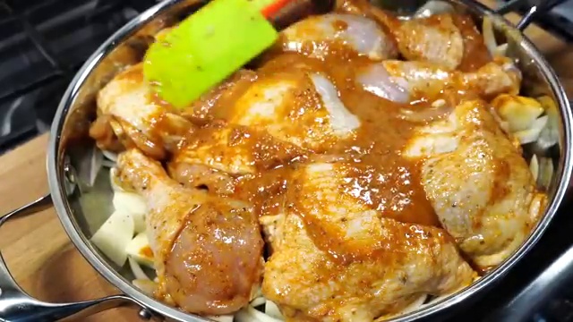 Rich chicken juices and rendered fat collecting at the bottom of the hot baking tray