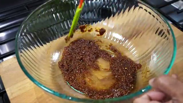 Herb and spice-coated chicken pieces resting in the bowl for secondary flavor absorption