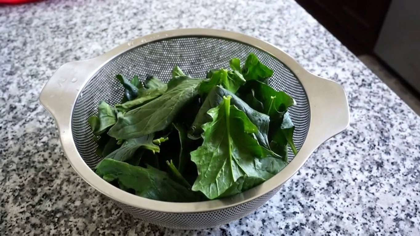 Chilled blanched spinach gently squeezed with hands to remove excess moisture
