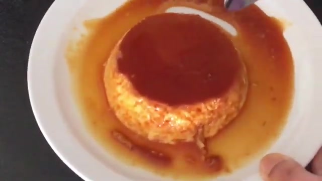 Chilled mango crème caramel served with caramel sauce and fresh mango garnish