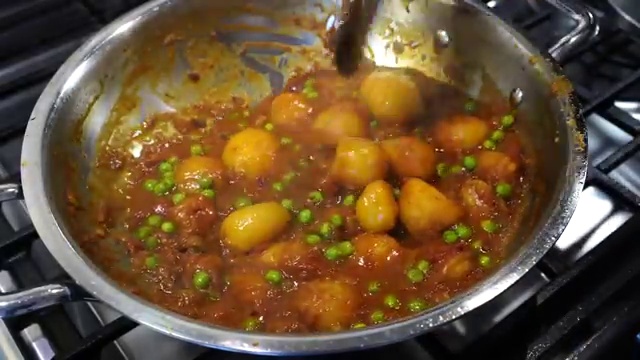 Freshly chopped coriander leaves sprinkled into the finished Aloo Dum curry