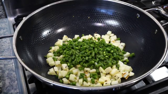 Fresh chopped green beans stirred into the pan with lightly fried potatoes