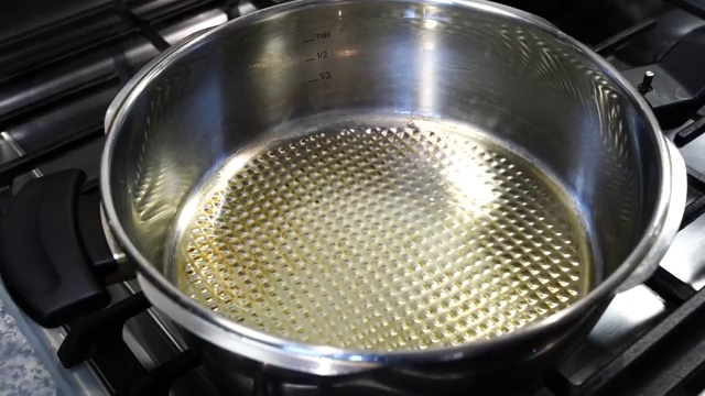 Finely chopped onions and asafoetida added to tempered whole spices in the cooker