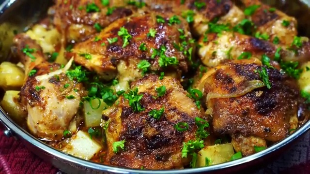 Complete dinner plate with baked buttermilk chicken, roasted potatoes, onions, and fresh salad
