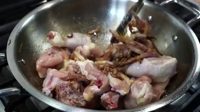 Chicken pieces searing over medium-high heat until natural cooking moisture evaporates