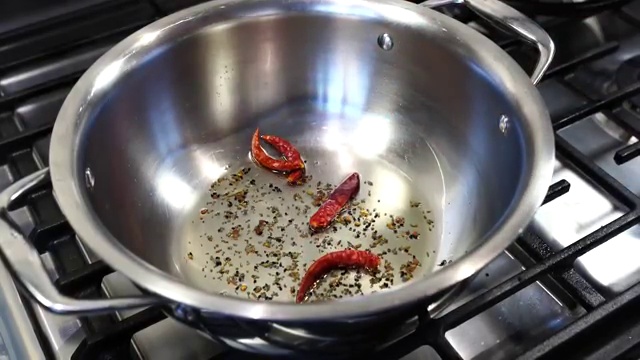 Cooked masoor dal poured directly into the sizzling pan of Bengali tadka