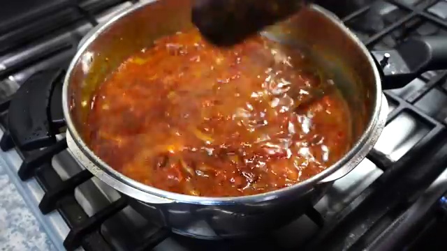 Cooked rajma curry with whole bay leaf and cinnamon stick ready to be removed