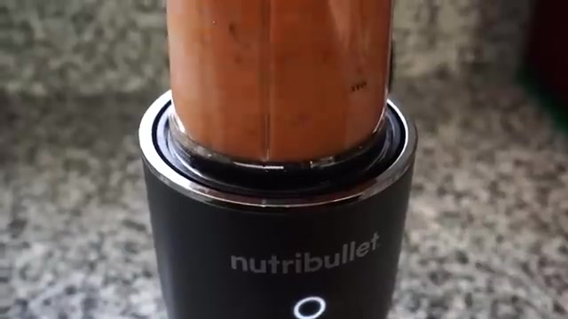 Cooked tomato sesame chutney mixture being blended into a smooth red paste