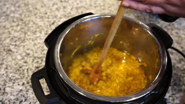 Cooked yellow tuvar dal in a pot with a soft creamy texture
