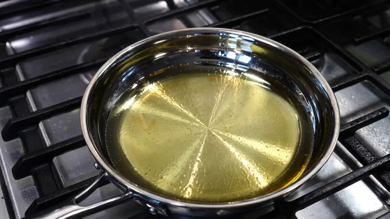 Cooking oil heating in a pan to near smoking point to eliminate moisture