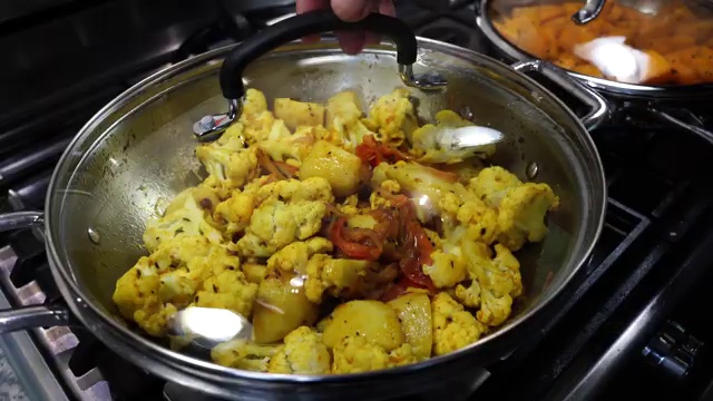 Pot covered with a lid to gently braise cauliflower and potatoes over medium heat