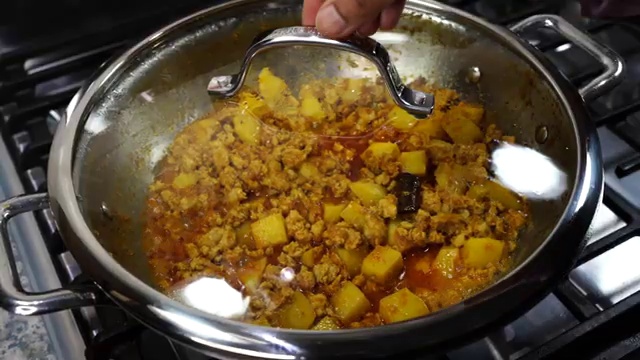 Pan covered with a lid to cook the chicken keema curry over medium-low heat