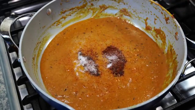 Crushed dried kasuri methi leaves sprinkled into the simmering curry sauce